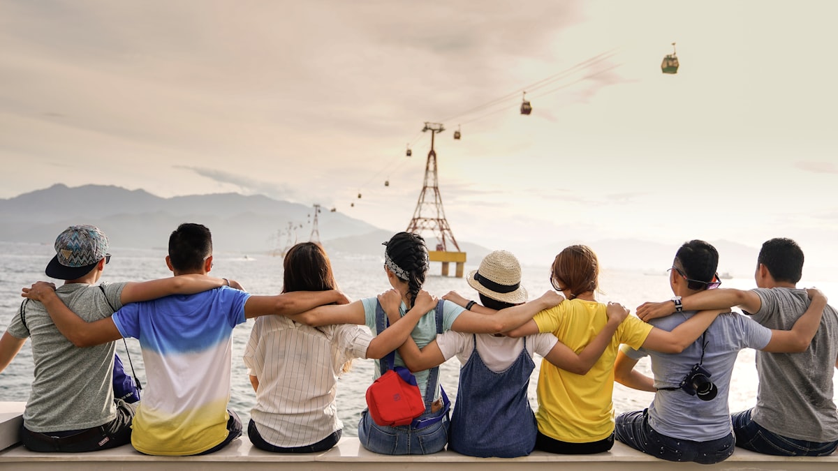 Friends sitting arm in arm